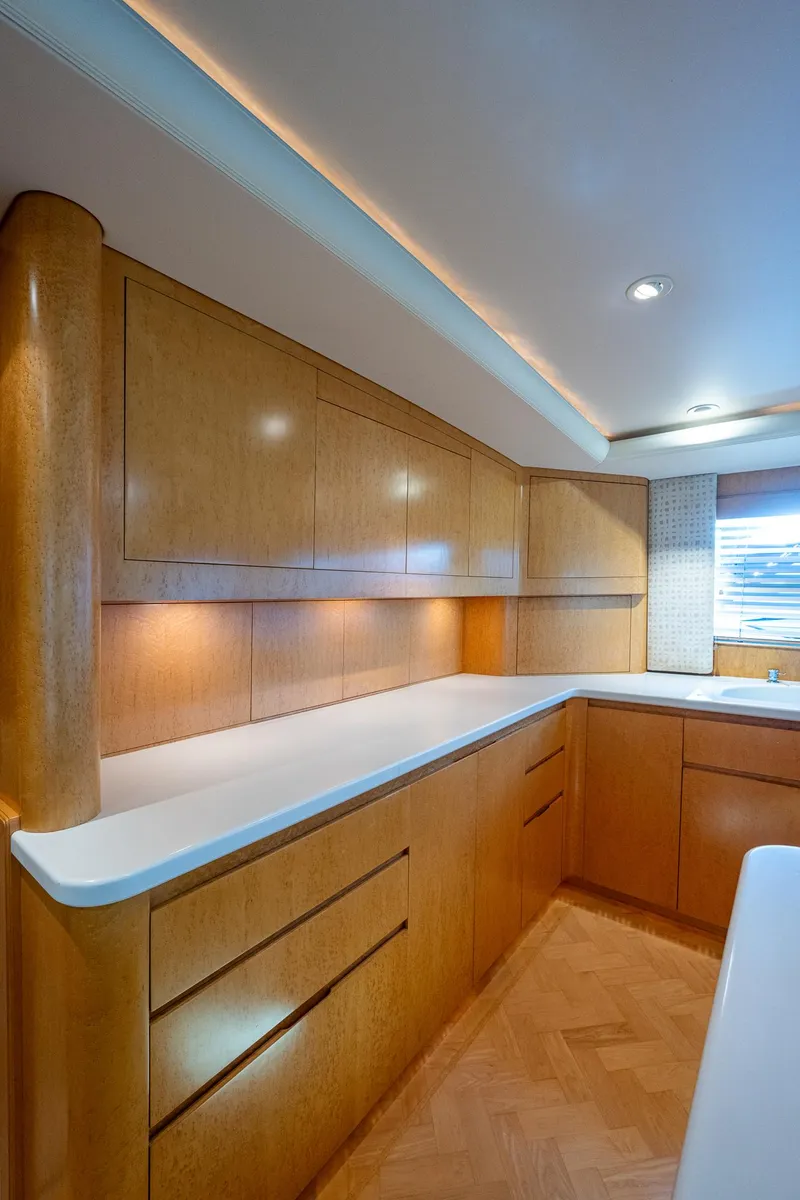 Slide: The Image of Luxurious wooden interior of a 2001 American Custom Enclosed Flybridge yacht kitchen. - 39