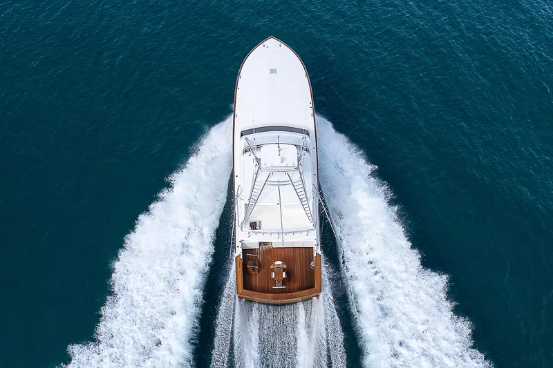 Slide: The Image of 2001 American Custom Enclosed Flybridge yacht cruising on open water, aerial view. - 4