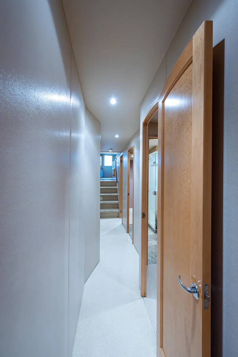 Slide: The Image of Hallway inside 2001 American Custom Enclosed Flybridge yacht with wooden doors and carpeted floor. - 45