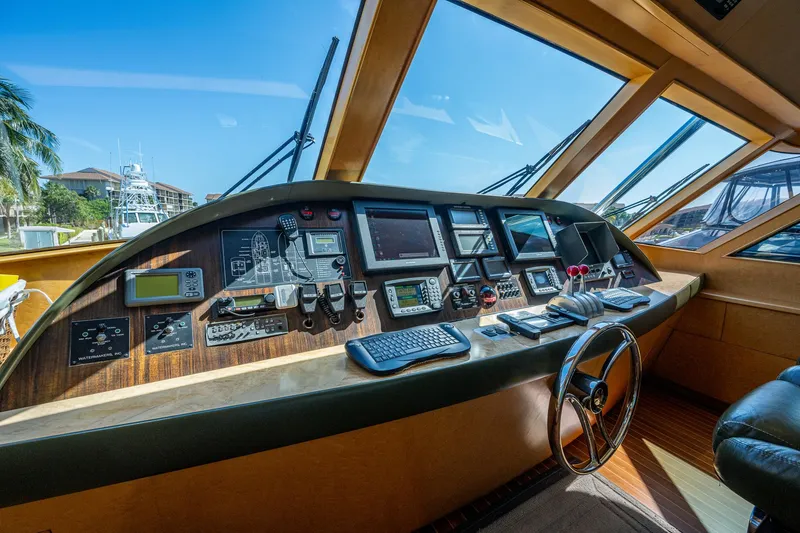 Slide: The Image of Control panel of a 2001 American Custom Enclosed Flybridge yacht with navigation equipment. - 8