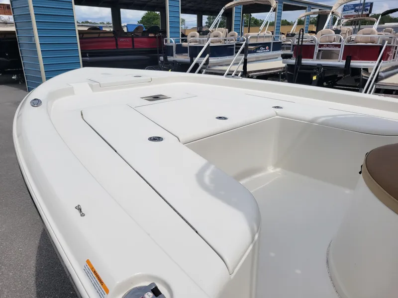 Slide: The Image of 2016 Ranger 220 Bahia boat deck, white finish, docked near other boats. - 11