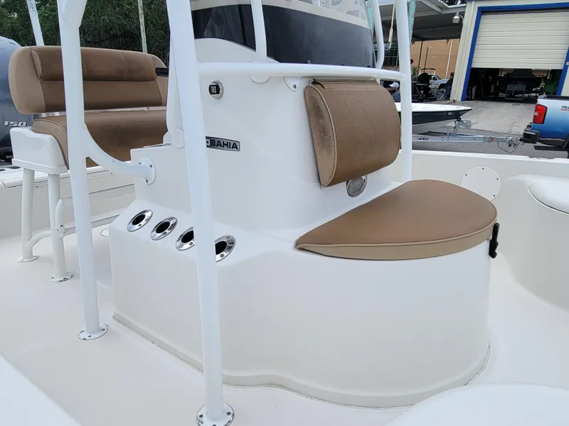 Slide: The Image of 2016 Ranger 220 Bahia boat interior with tan seating and console. - 16
