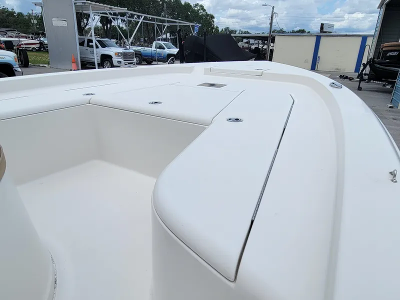 Slide: The Image of 2016 Ranger 220 Bahia boat deck, spacious and clean, parked outdoors. - 17