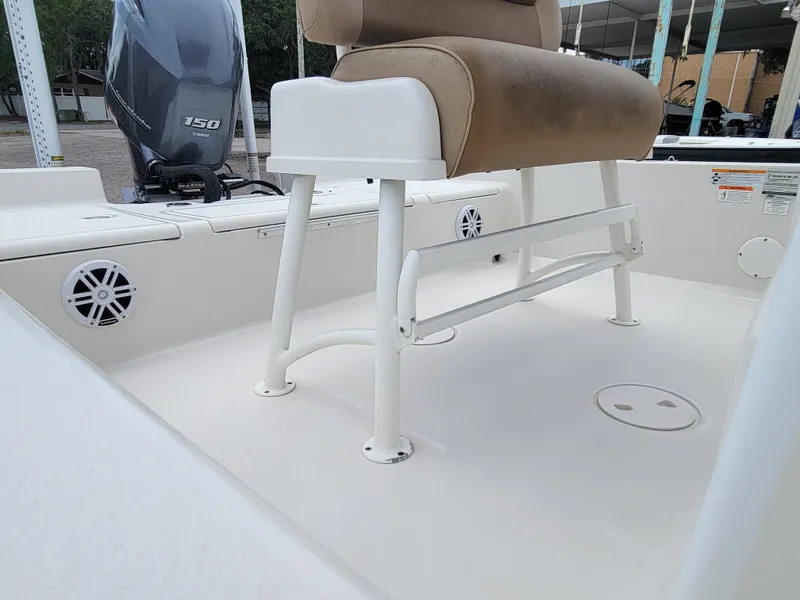 Slide: The Image of 2016 Ranger 220 Bahia boat interior with seating and motor, showcasing clean design. - 19
