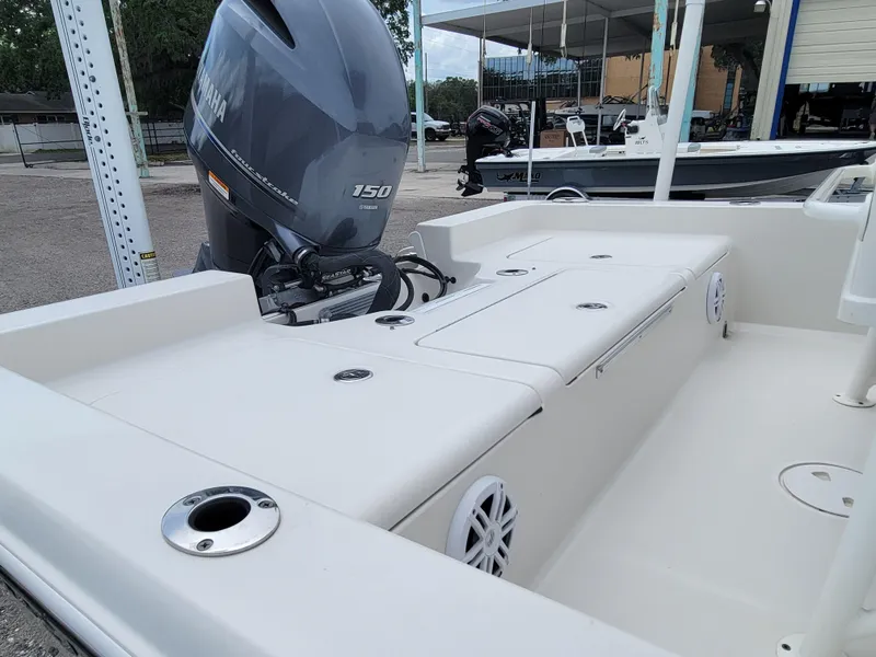 Slide: The Image of 2016 Ranger 220 Bahia boat with Yamaha 150 engine, docked outdoors. - 20