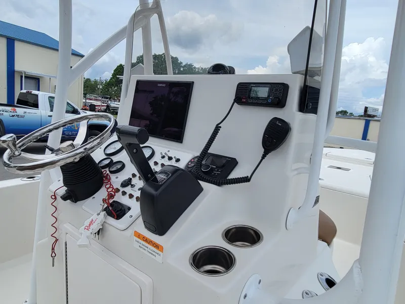 Slide: The Image of Control console of a 2016 Ranger 220 Bahia boat with steering wheel and navigation equipment. - 21