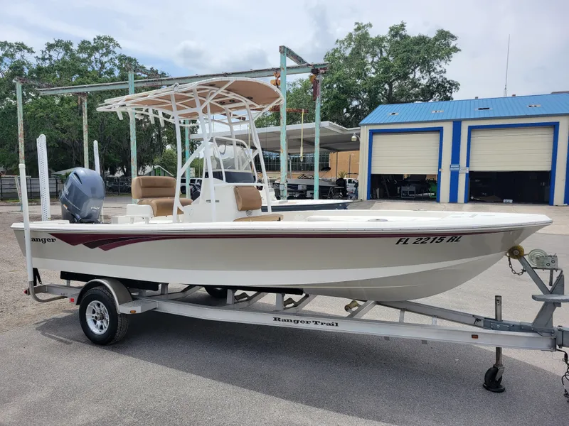 Slide: The Image of 2016 Ranger 220 Bahia boat on trailer, parked outdoors near blue garage. - 3