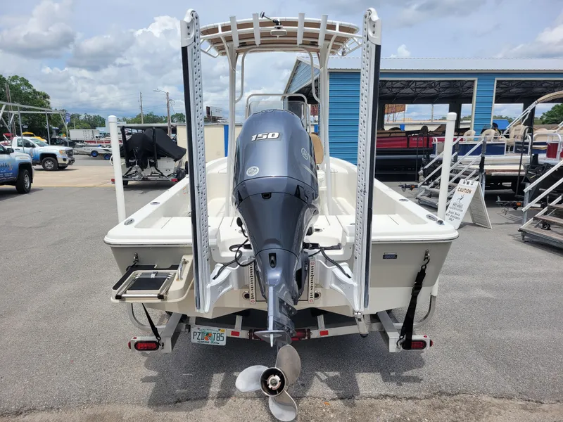 Slide: The Image of 2016 Ranger 220 Bahia boat with outboard motor in a marina setting. - 5