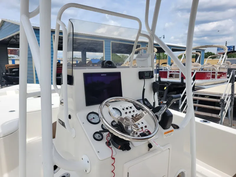 Slide: The Image of 2016 Ranger 220 Bahia boat console with steering wheel and navigation equipment. - 8