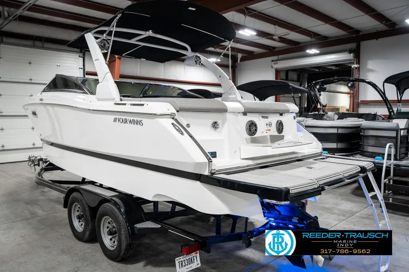 Slide: The Image of 2021 Four Winns H260 boat on trailer in indoor showroom. - 10