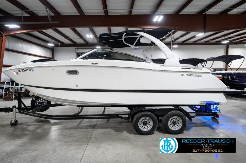 Slide: The Image of 2021 Four Winns H260 boat on trailer in indoor showroom. - 11