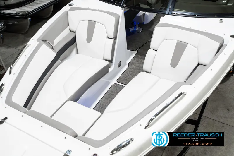 Slide: The Image of 2021 Four Winns H260 boat interior with white and gray seating, Reeder-Trausch Marine logo visible. - 12