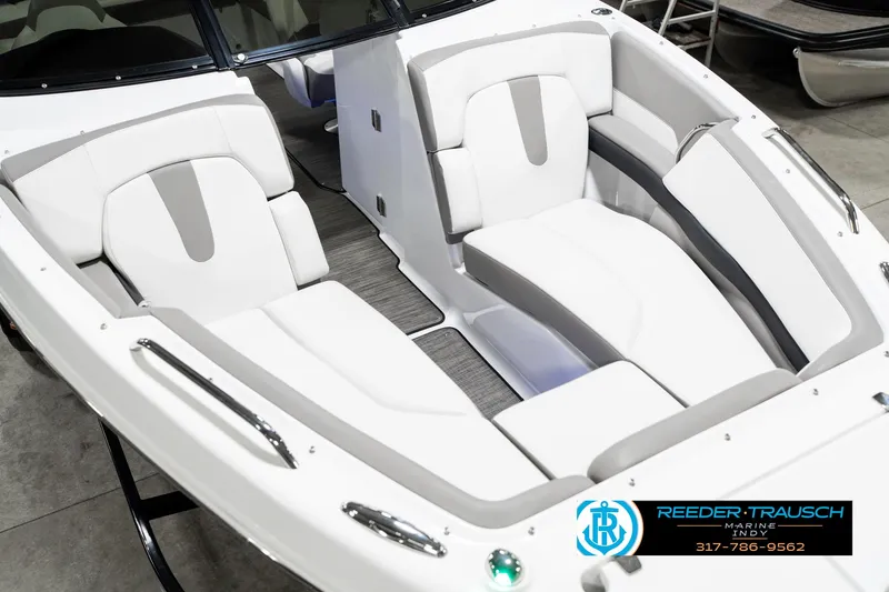 Slide: The Image of 2021 Four Winns H260 boat interior with white and gray seating, showcased at Reeder-Trausch Marine. - 13