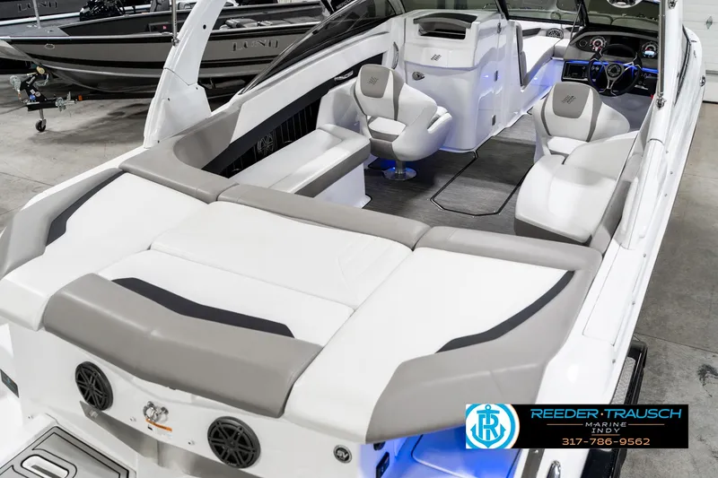 Slide: The Image of 2021 Four Winns H260 boat interior with plush seating and modern dashboard. - 14