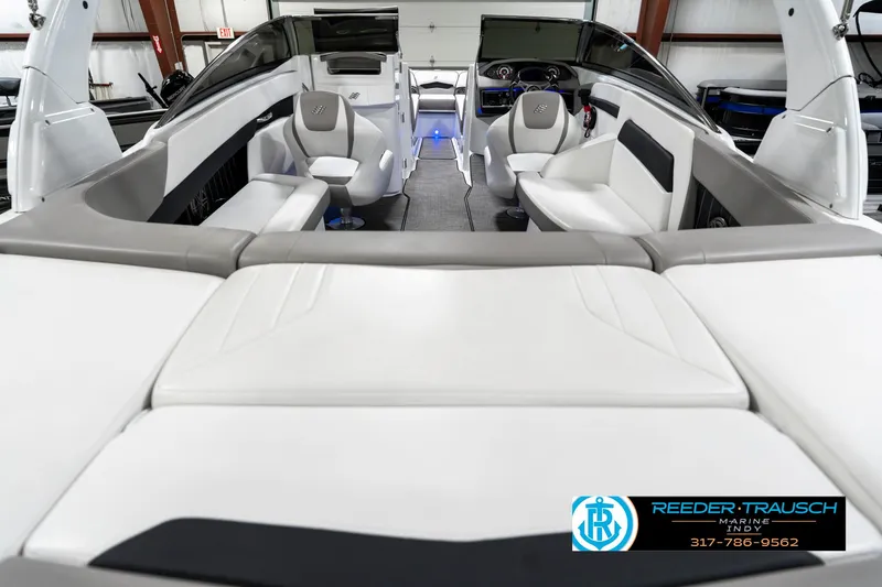 Slide: The Image of 2021 Four Winns H260 boat interior with white seating and modern dashboard. - 16