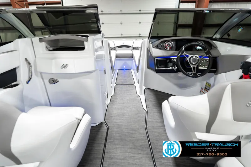 Slide: The Image of Interior view of 2021 Four Winns H260 boat, featuring sleek design and modern dashboard. - 17