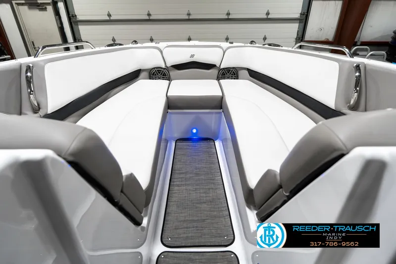 Slide: The Image of Interior of 2021 Four Winns H260 boat with white and gray seating, blue LED lighting. - 18