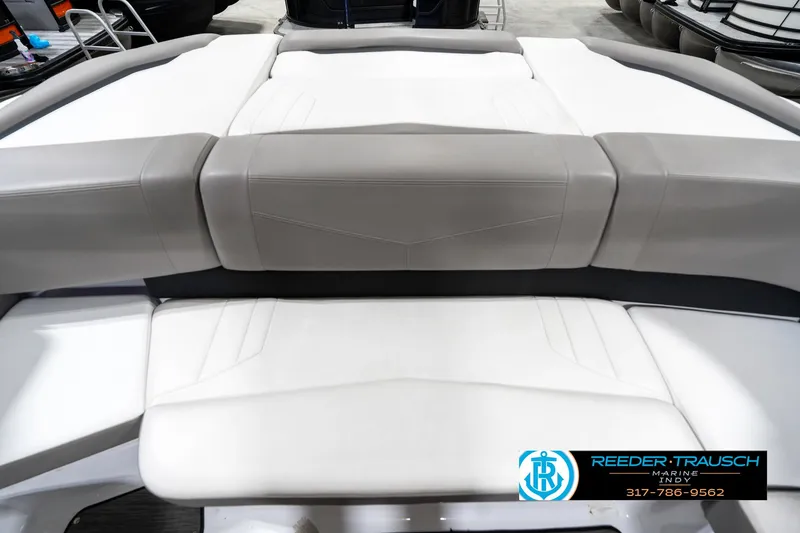 Slide: The Image of 2021 Four Winns H260 boat interior with gray and white seating, Reeder-Trausch Marine logo visible. - 21
