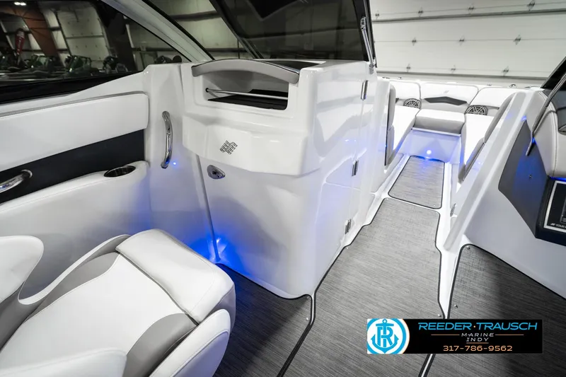 Slide: The Image of Interior of 2021 Four Winns H260 boat with modern seating and ambient lighting. - 24