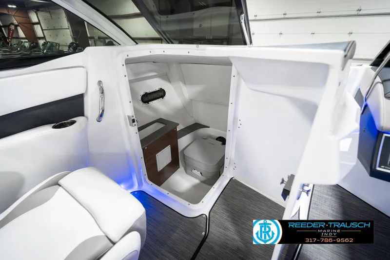 Slide: The Image of 2021 Four Winns H260 boat interior with compact restroom and modern design. - 25