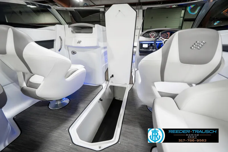 Slide: The Image of 2021 Four Winns H260 boat interior with white seating and storage compartment. - 27