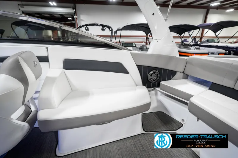 Slide: The Image of 2021 Four Winns H260 boat interior with sleek white and gray seating. - 28