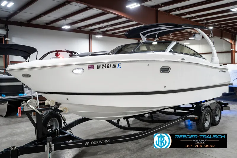 Slide: The Image of 2021 Four Winns H260 boat on trailer in indoor showroom. - 3