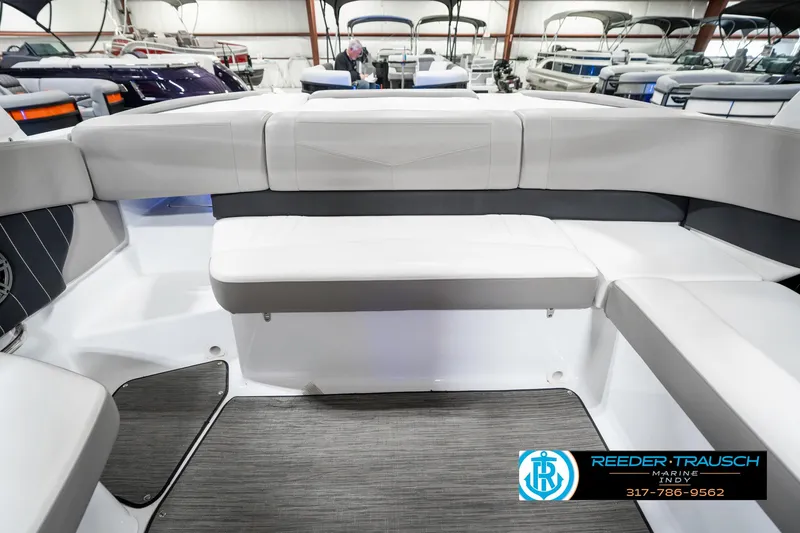 Slide: The Image of 2021 Four Winns H260 boat interior with gray seating and flooring in showroom. - 31