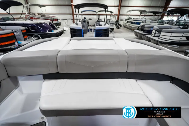 Slide: The Image of 2021 Four Winns H260 boat interior with cushioned seating in a showroom. - 35