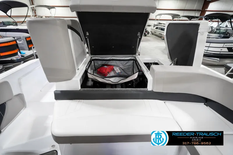 Slide: The Image of 2021 Four Winns H260 boat interior with open storage compartment in showroom. - 36