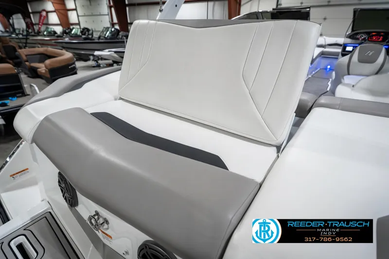 Slide: The Image of 2021 Four Winns H260 boat interior with gray and white seating in showroom. - 38