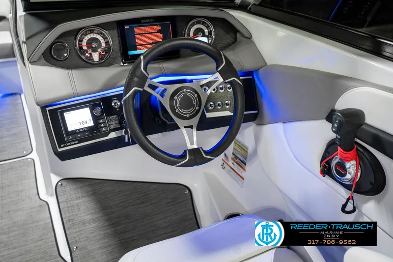 Slide: The Image of 2021 Four Winns H260 boat dashboard with steering wheel and control panel. - 40