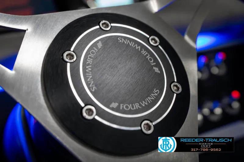 Slide: The Image of Steering wheel detail of 2021 Four Winns H260 boat with logo and branding. - 41