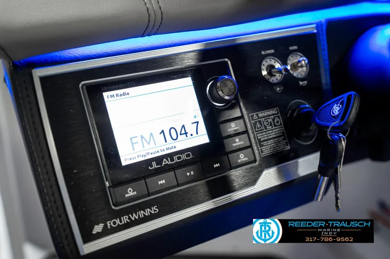 Slide: The Image of Control panel of a 2021 Four Winns H260 boat with JL Audio system. - 42