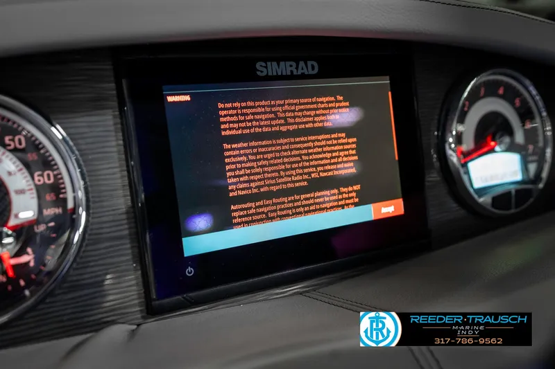 Slide: The Image of Dashboard of a 2021 Four Winns H260 boat featuring a Simrad display. - 44
