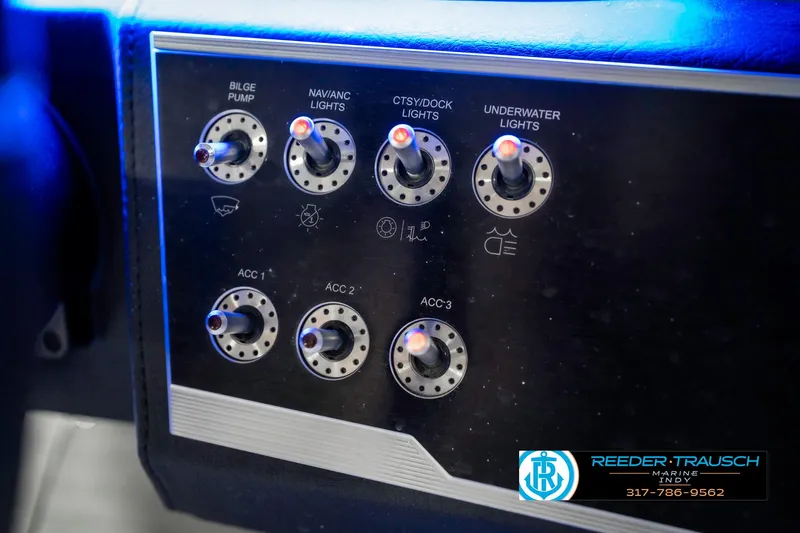 Slide: The Image of Control panel of a 2021 Four Winns H260 boat with various light switches. - 46