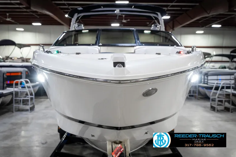 Slide: The Image of 2021 Four Winns H260 boat in showroom, front view with sleek design and modern features. - 5