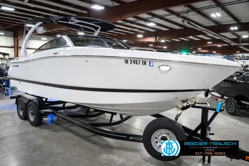 Slide: The Image of 2021 Four Winns H260 boat on trailer in indoor showroom. - 6