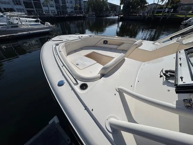 Slide: The Image of 2021 Grady-White Freedom 335 boat docked, featuring spacious seating and sleek design. - 12