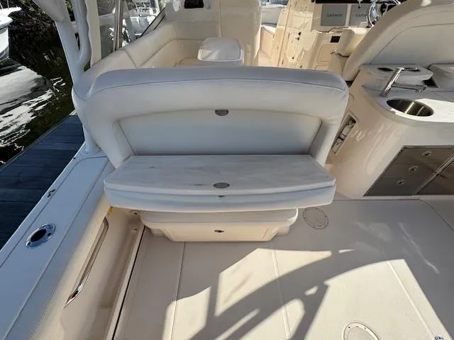 Slide: The Image of 2021 Grady-White Freedom 335 boat interior with white seating and deck features. - 13
