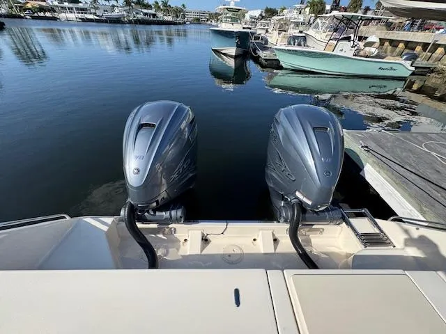 Slide: The Image of 2021 Grady-White Freedom 335 boat with dual outboard engines docked at marina. - 14