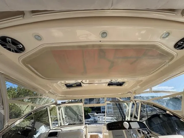 Slide: The Image of 2021 Grady-White Freedom 335 boat interior with sunroof and modern controls. - 15