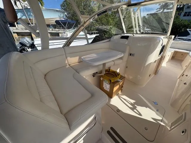 Slide: The Image of 2021 Grady-White Freedom 335 boat interior with white seating and table. - 16
