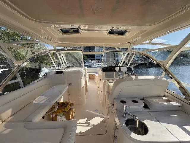 Slide: The Image of 2021 Grady-White Freedom 335 boat interior with helm, seating, and kitchenette. - 17