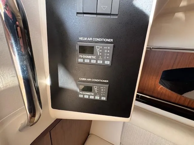 Slide: The Image of 2021 Grady-White Freedom 335 boat air conditioning controls, featuring Dometic helm and cabin units. - 22