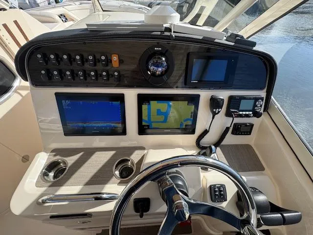Slide: The Image of 2021 Grady-White Freedom 335 helm with navigation screens and controls. - 26
