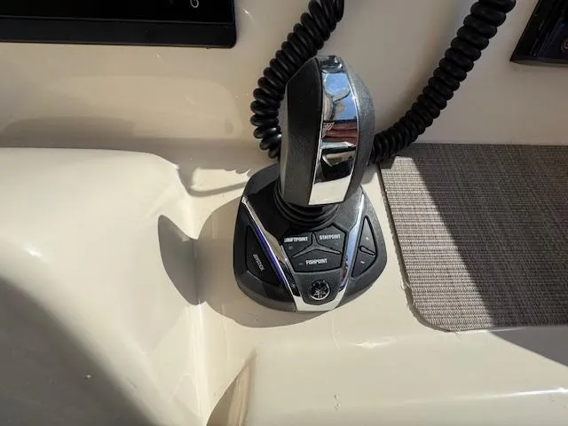 Slide: The Image of Control panel of a 2021 Grady-White Freedom 335 boat, featuring a joystick and buttons. - 27