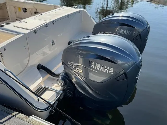 Slide: The Image of 2021 Grady-White Freedom 335 boat with dual Yamaha outboard engines docked on water. - 3
