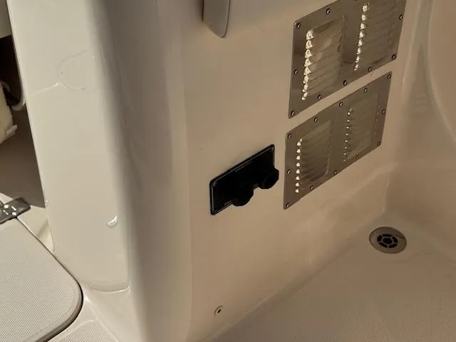 Slide: The Image of 2021 Grady-White Freedom 335 boat interior with ventilation panels and drain. - 32