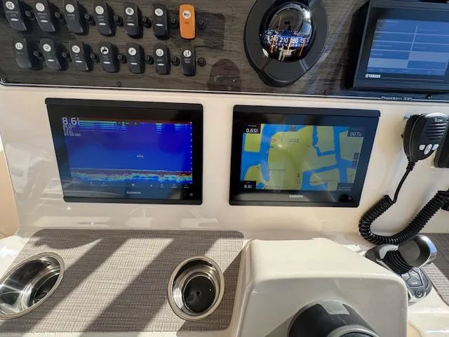 Slide: The Image of 2021 Grady-White Freedom 335 dashboard with navigation and sonar displays. - 34